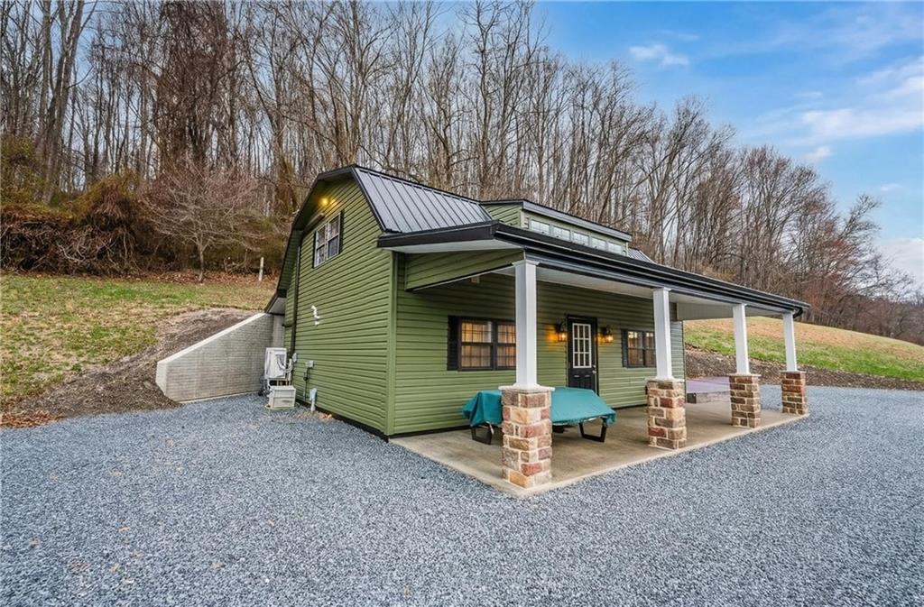 143 Chimney Ridge Road Bedford, PA 15522 - Photo 4 of 50 a front view of a house with garden