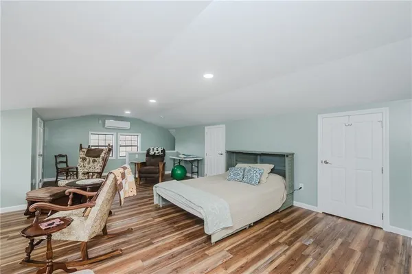 a bedroom with furniture and a window