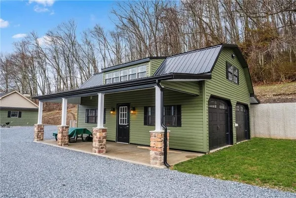 a view of a house with a patio and a yard
