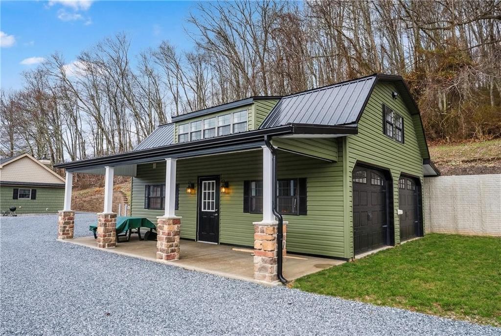 143 Chimney Ridge Road Bedford, PA 15522 - Photo 5 of 50 a view of a house with a patio and a yard