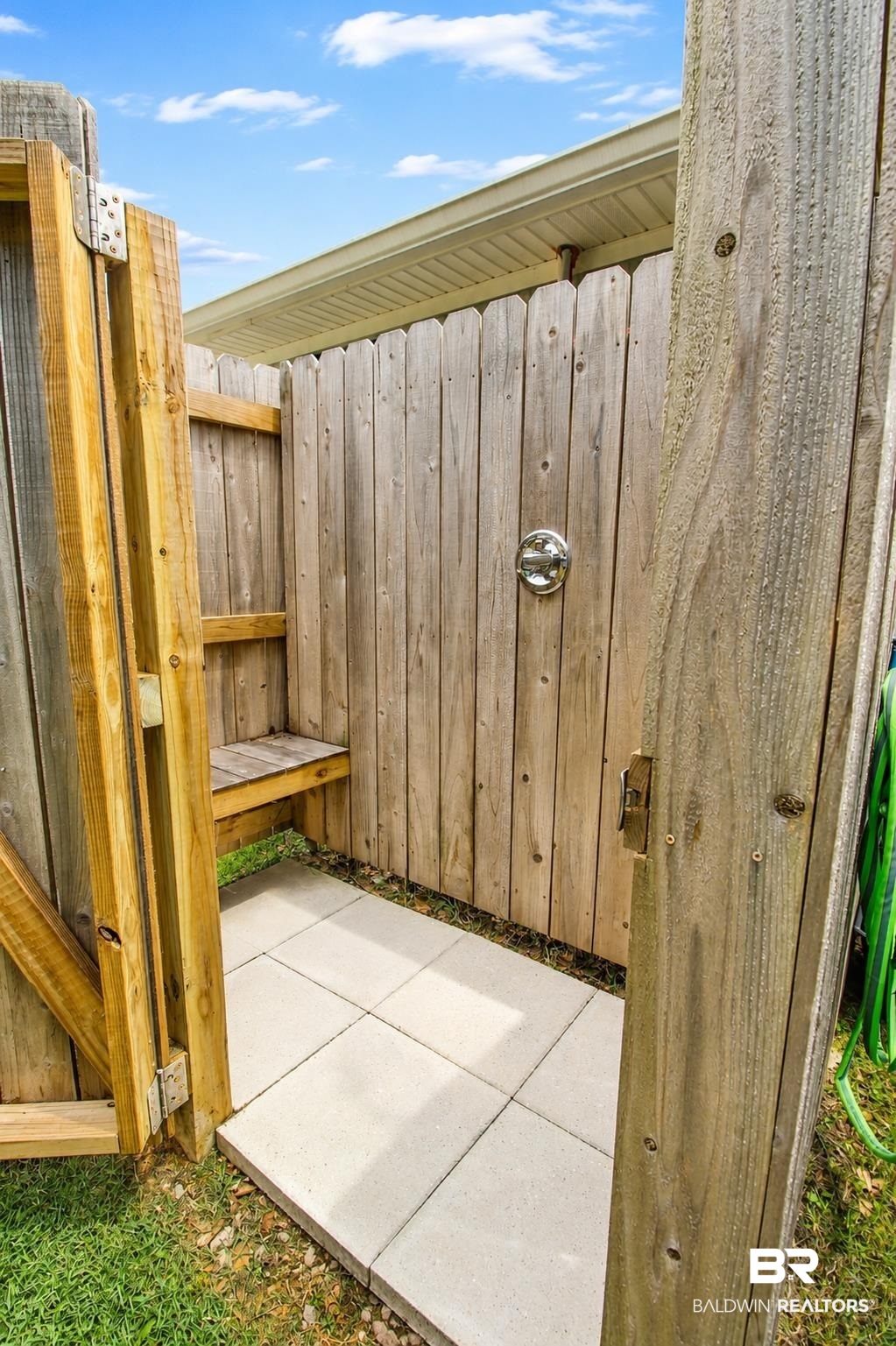 9825 Wolf Creek Ridge Elberta, AL 36530 - Photo 57 of 76 Enclosed outdoor shower featuring wood paneling, a built-in wood bench, and square paver flooring