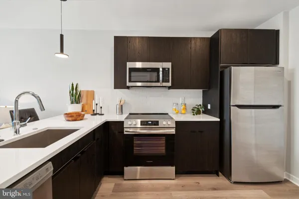 a kitchen with a refrigerator and a sink