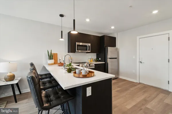 a open kitchen with a dining table and chairs