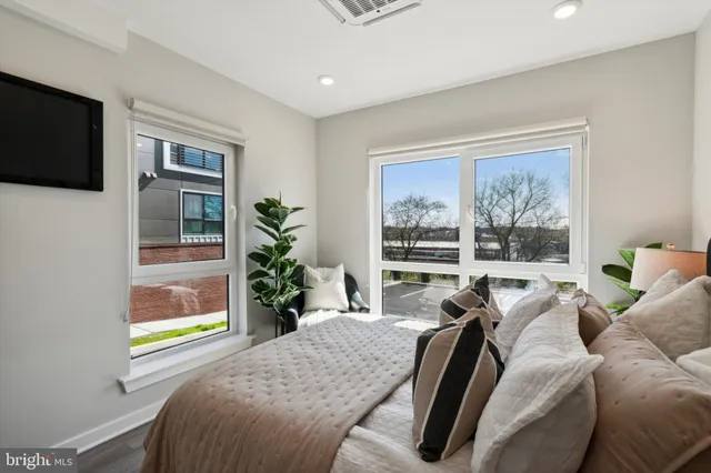 a living room with furniture tv and a window
