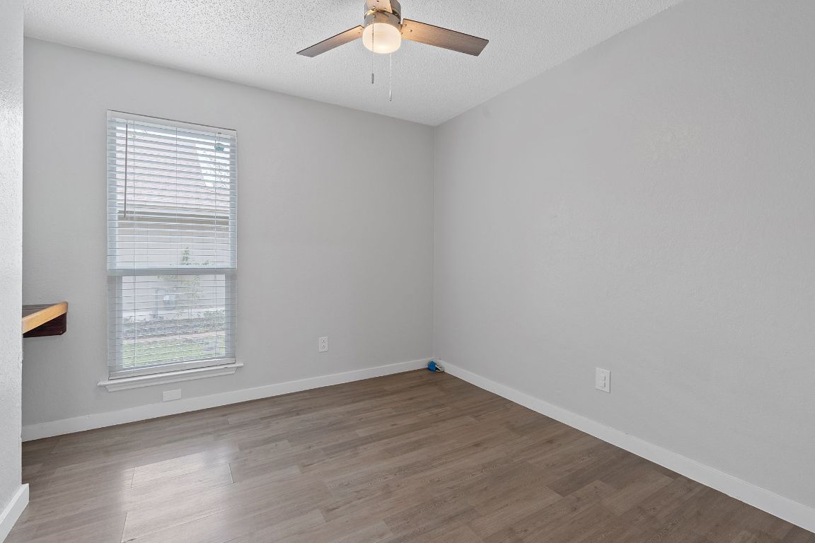 16131 Stoneham Circle Pflugerville, TX 78660 - Photo 13 of 19 an empty room with a window and a ceiling fan