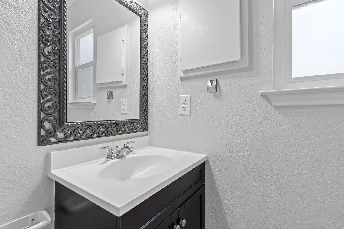 16131 Stoneham Circle Pflugerville, TX 78660 - Photo 16 of 19 a bathroom with a sink and a mirror