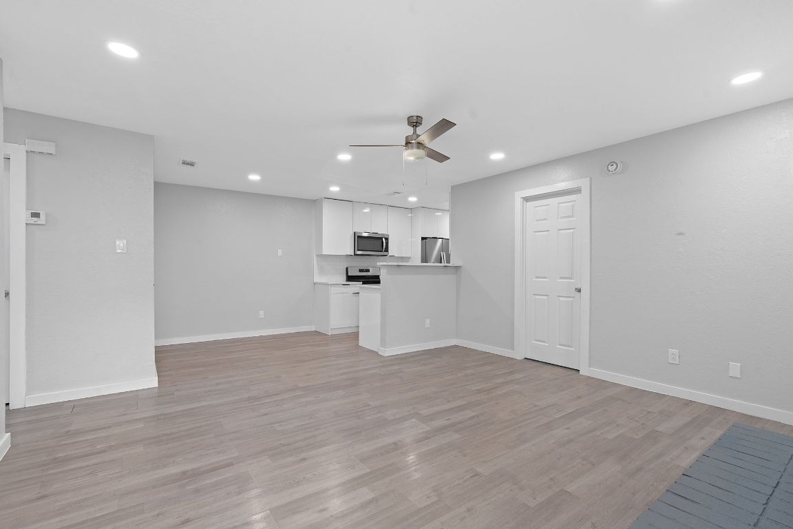 16131 Stoneham Circle Pflugerville, TX 78660 - Photo 4 of 19 a view of a kitchen with a sink and a refrigerator