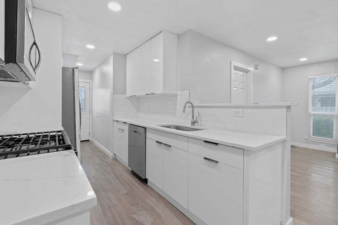 16131 Stoneham Circle Pflugerville, TX 78660 - Photo 7 of 19 a kitchen with a sink stove and cabinets