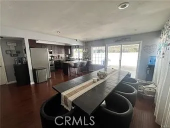 a kitchen with stainless steel appliances granite countertop a sink a stove and refrigerator