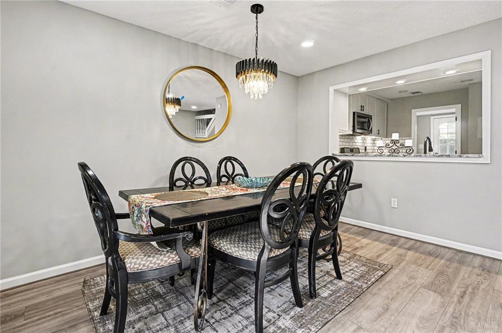 6052 WinterGreen Road Northwest Norcross, GA 30093 - Photo 6 of 24 a view of a dining room with furniture and chandelier
