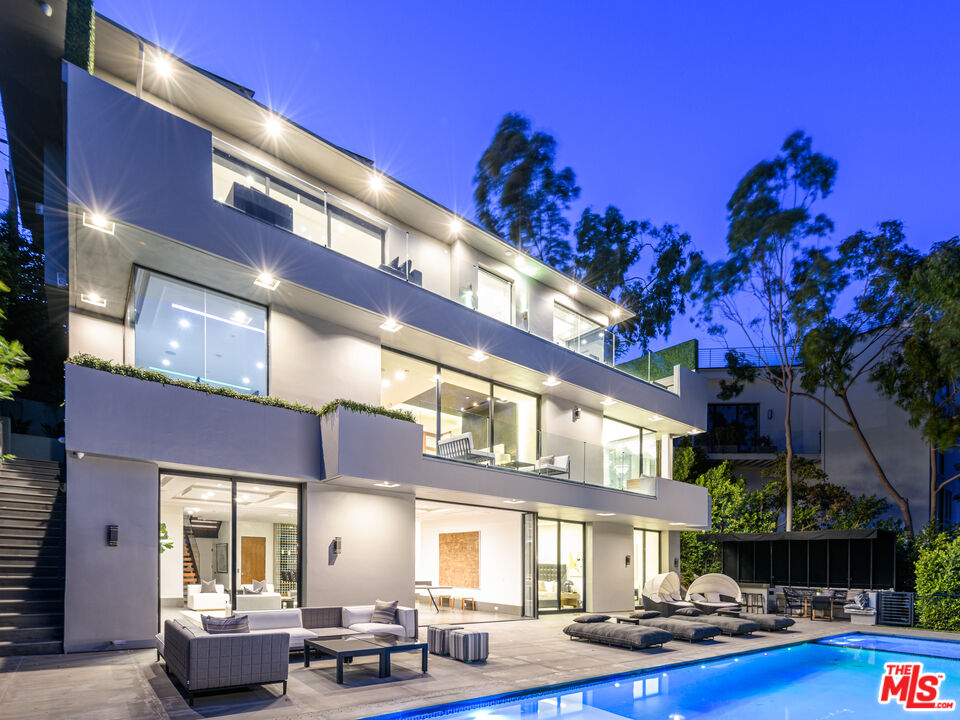 a large building with swimming pool in front of it