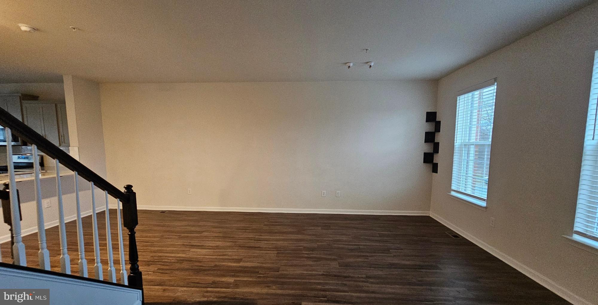 5147 Constitution Street Frederick, MD 21703 - Photo 12 of 23 a view of an empty room with wooden floor and white walls