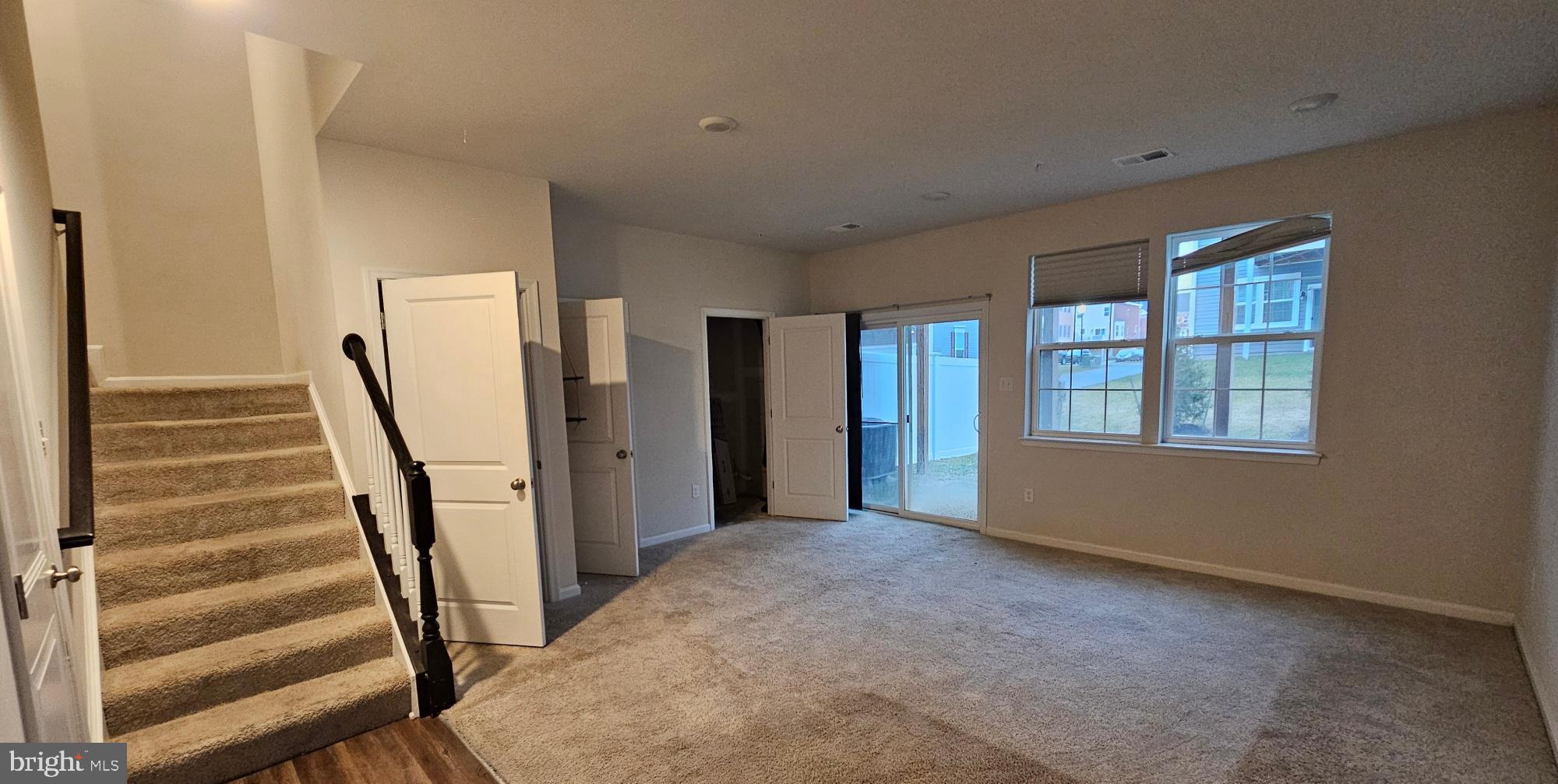 5147 Constitution Street Frederick, MD 21703 - Photo 4 of 23 a view of an empty room with stairs and a window