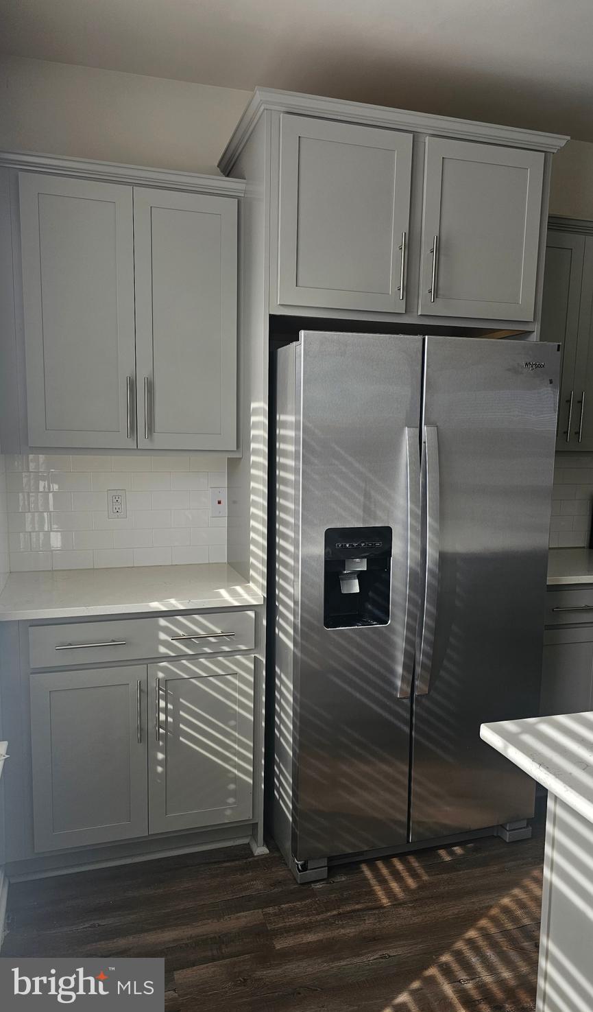 5147 Constitution Street Frederick, MD 21703 - Photo 8 of 23 a close view of a refrigerator in kitchen and an empty room