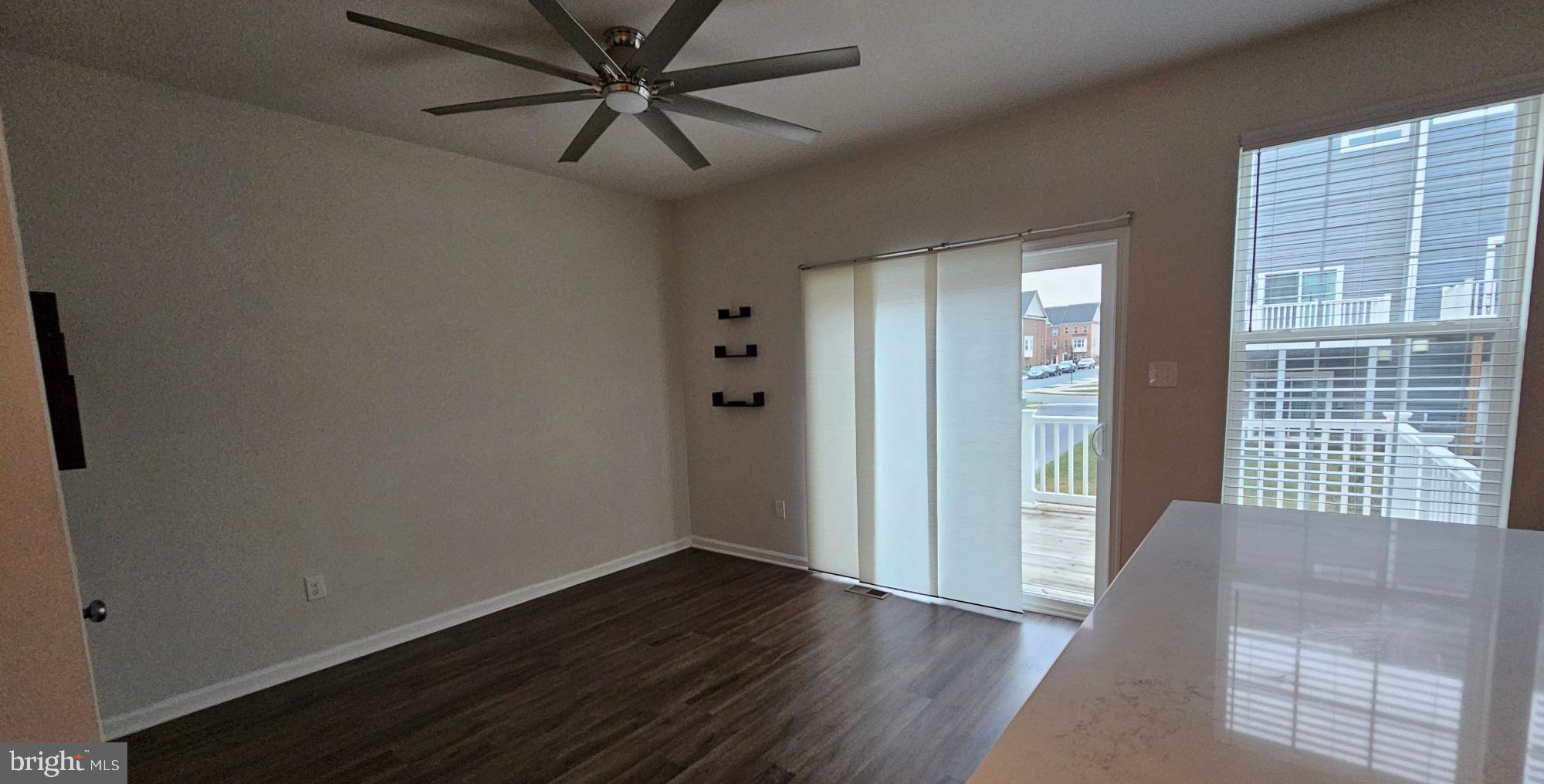5147 Constitution Street Frederick, MD 21703 - Photo 9 of 23 an empty room with wooden floor and windows
