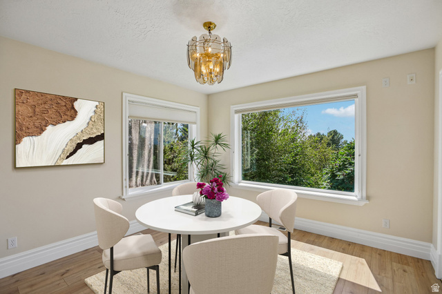 220 East Ridge Road Orem, UT 84057 - Photo 12 of 52 Warm wood-finish flooring, a contemporary chandelier, and multiple windows with white trim