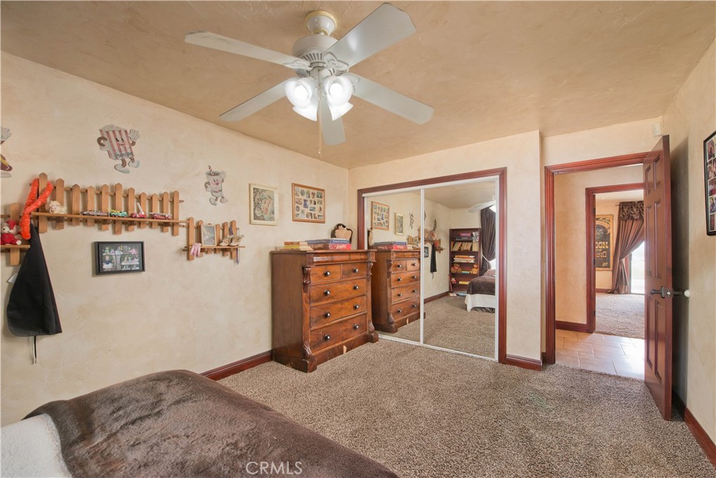 30602 Hasley Canyon Road Castaic, CA 91384 - Photo 26 of 72 a view of a bedroom with furniture and a chandelier