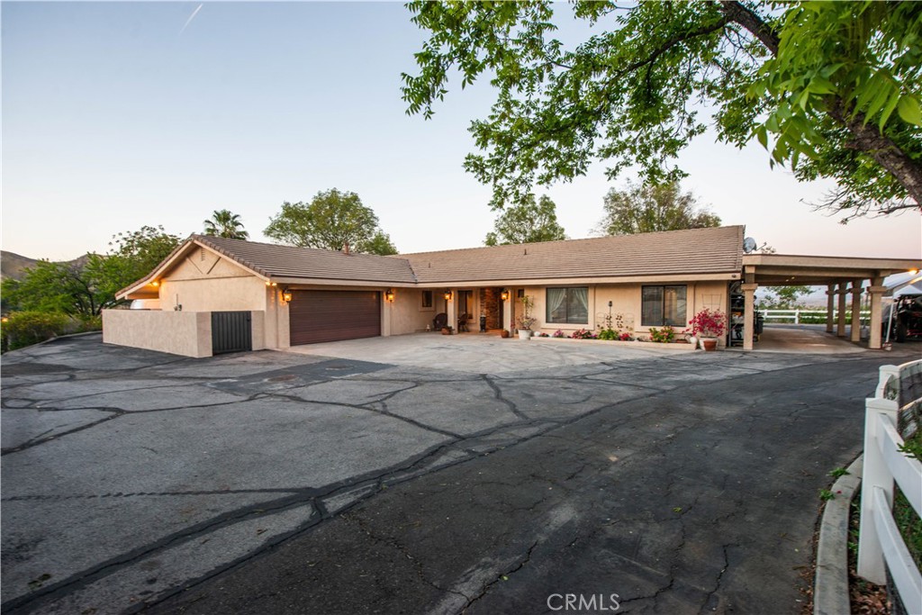 30602 Hasley Canyon Road Castaic, CA 91384 - Photo 3 of 72 a front view of a house with a yard and garage