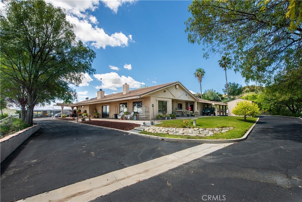 30602 Hasley Canyon Road Castaic, CA 91384 - Photo 32 of 72 a front view of a house with a garden