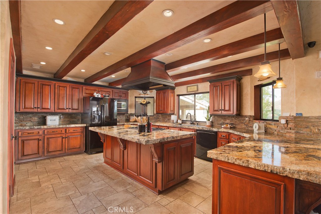 30602 Hasley Canyon Road Castaic, CA 91384 - Photo 4 of 72 a kitchen with stainless steel appliances granite countertop wooden cabinets and sink