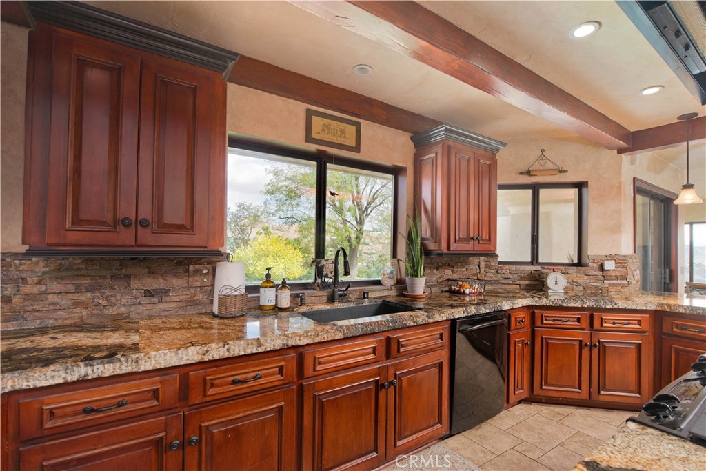 30602 Hasley Canyon Road Castaic, CA 91384 - Photo 6 of 72 a kitchen with stainless steel appliances granite countertop wooden cabinets a sink and dishwasher with wooden floor