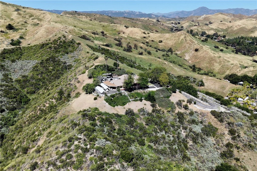 30602 Hasley Canyon Road Castaic, CA 91384 - Photo 66 of 72 an aerial view of a houses with a lush green hillside