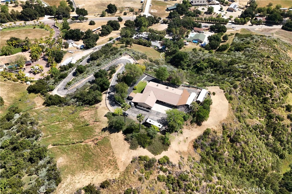 30602 Hasley Canyon Road Castaic, CA 91384 - Photo 69 of 72 an aerial view of residential house with parking space and covered with trees