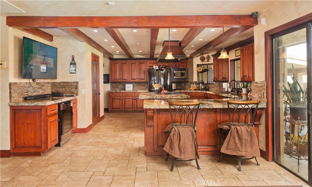 30602 Hasley Canyon Road Castaic, CA 91384 - Photo 8 of 72 a kitchen with a sink and a refrigerator