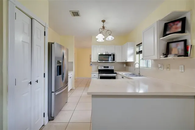 a kitchen with stainless steel appliances a refrigerator sink and stove