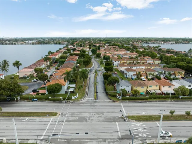 an aerial view of multiple houses with a yard