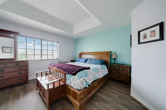 a bedroom with a bed chair and a window