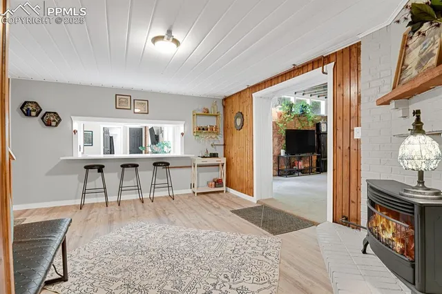 a living room with furniture a rug and a flat screen tv