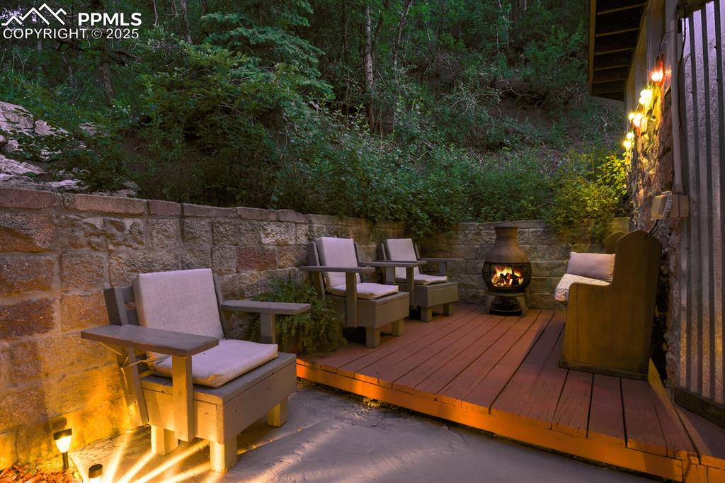4540 Fountain Avenue Cascade, CO 80809 - Photo 20 of 50 an outdoor sitting area with chairs and a table