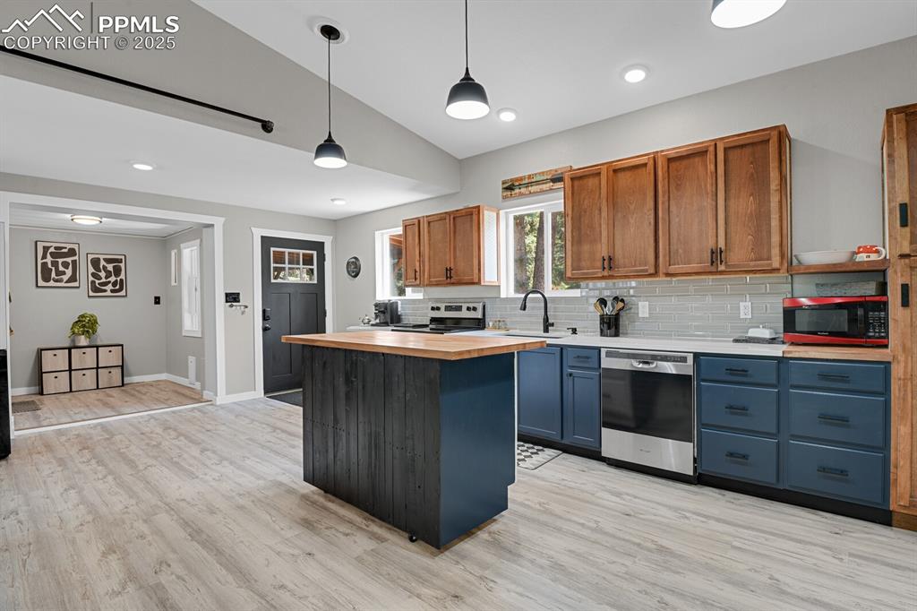 4540 Fountain Avenue Cascade, CO 80809 - Photo 2 of 50 a kitchen with granite countertop a stove cabinets and wooden floor