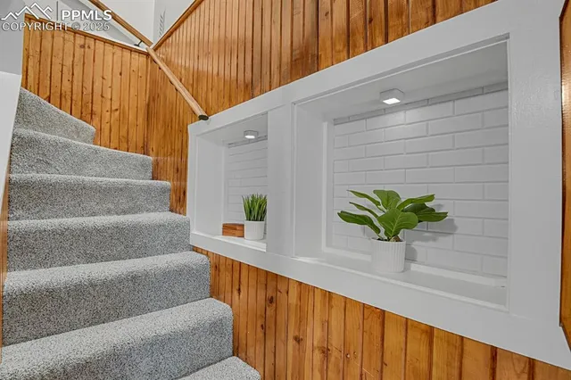 a view of staircase with wooden floor