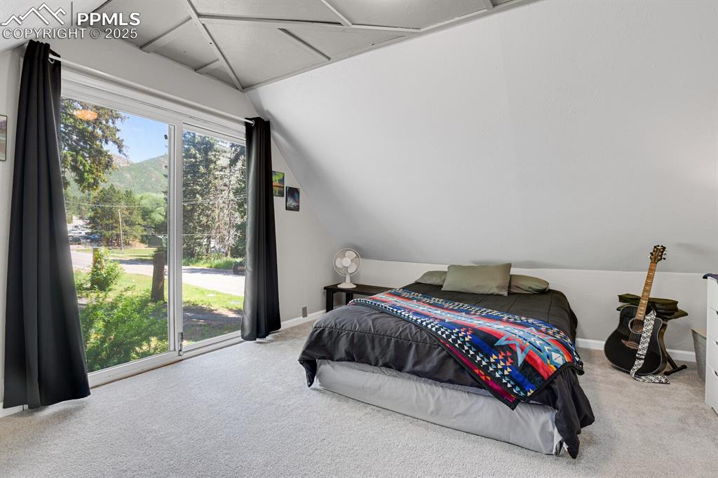 4540 Fountain Avenue Cascade, CO 80809 - Photo 31 of 50 a bedroom with a bed and a large window