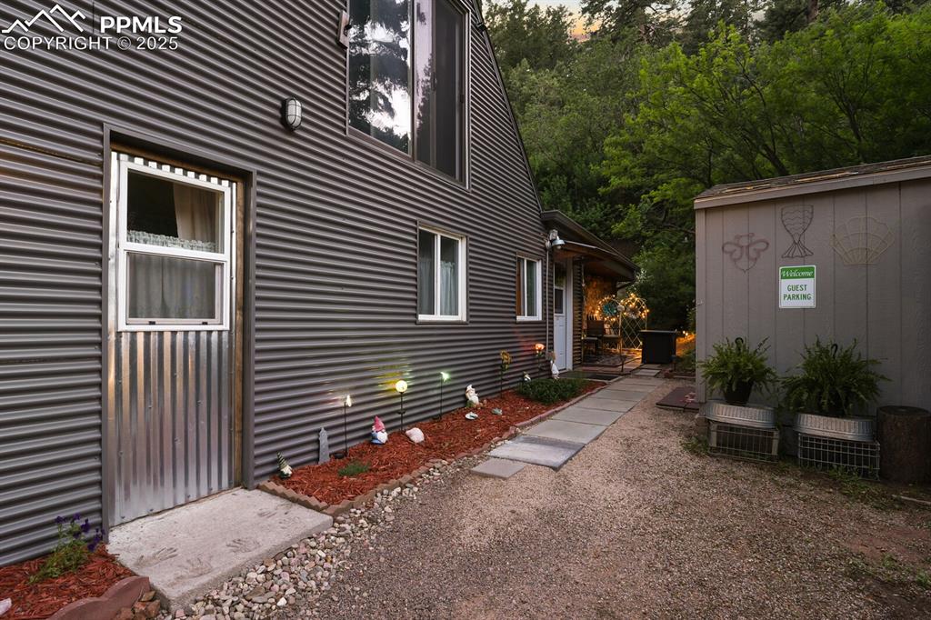 4540 Fountain Avenue Cascade, CO 80809 - Photo 32 of 50 a backyard of a house with potted plants and large tree