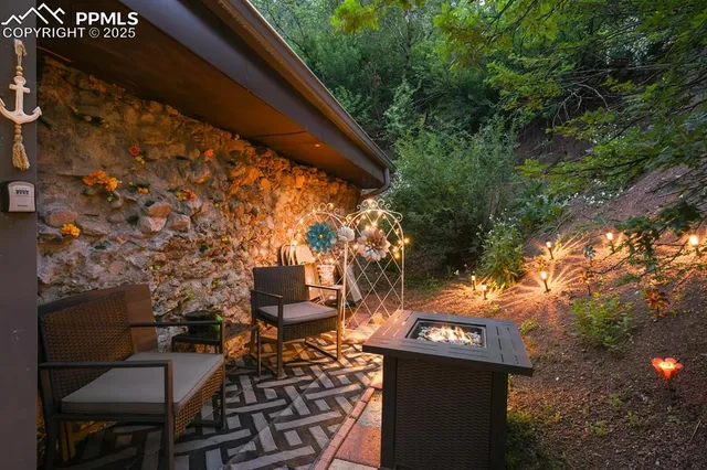 a backyard of a house with table and chairs