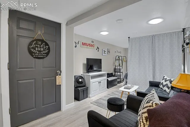 a living room with furniture and a flat screen tv