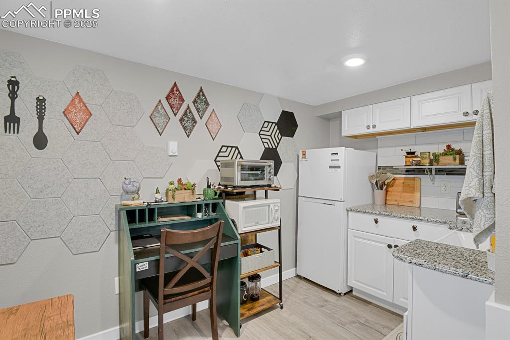 4540 Fountain Avenue Cascade, CO 80809 - Photo 36 of 50 a kitchen with a refrigerator and a stove top oven