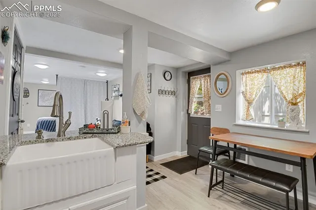 a bathroom with a sink a large mirror and a window