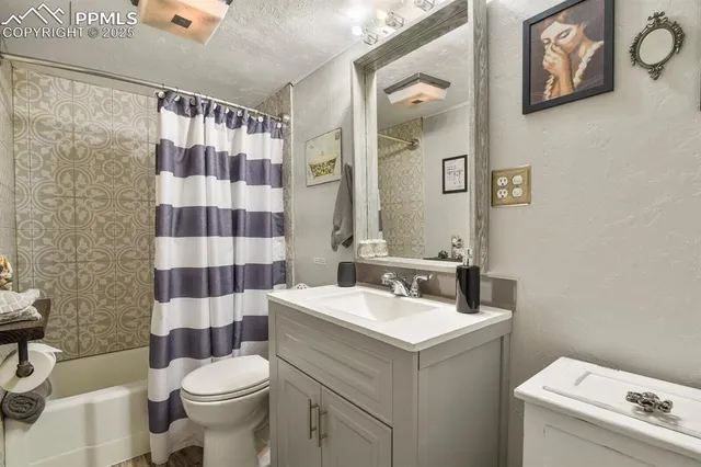 a bedroom with bed and wall painting