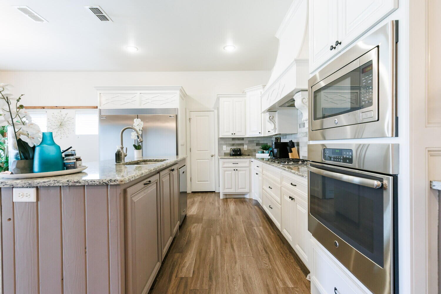 3812 135th Street Lubbock, TX 79423 - Photo 12 of 41 a kitchen with granite countertop white cabinets and white appliances