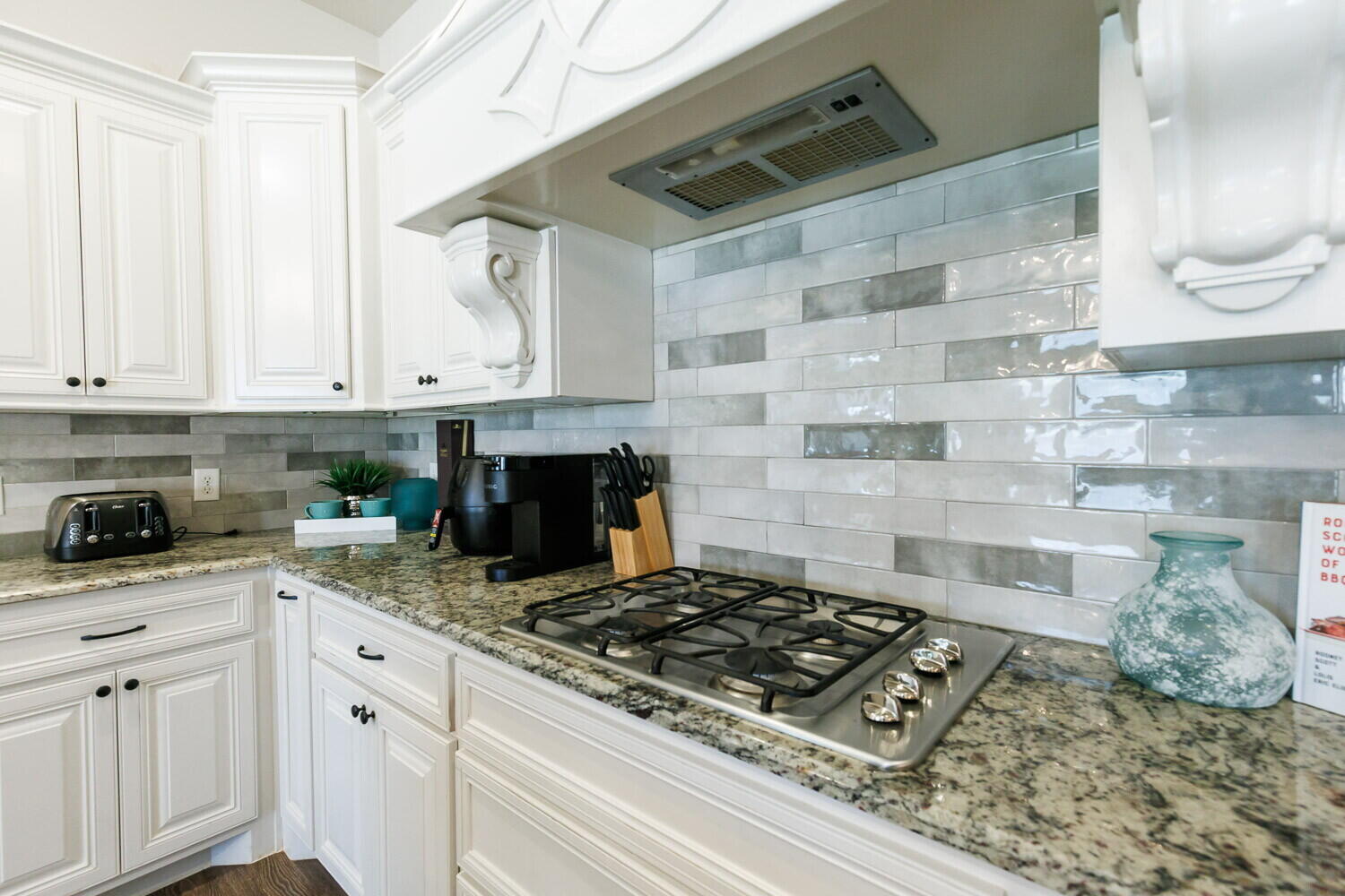 3812 135th Street Lubbock, TX 79423 - Photo 13 of 41 a kitchen with white cabinets and appliances