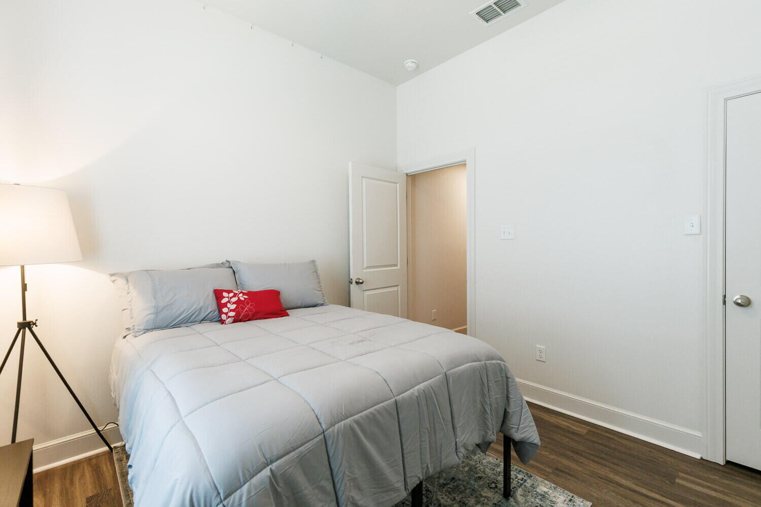 3812 135th Street Lubbock, TX 79423 - Photo 21 of 41 a bedroom with a bed and a lamp on the dresser