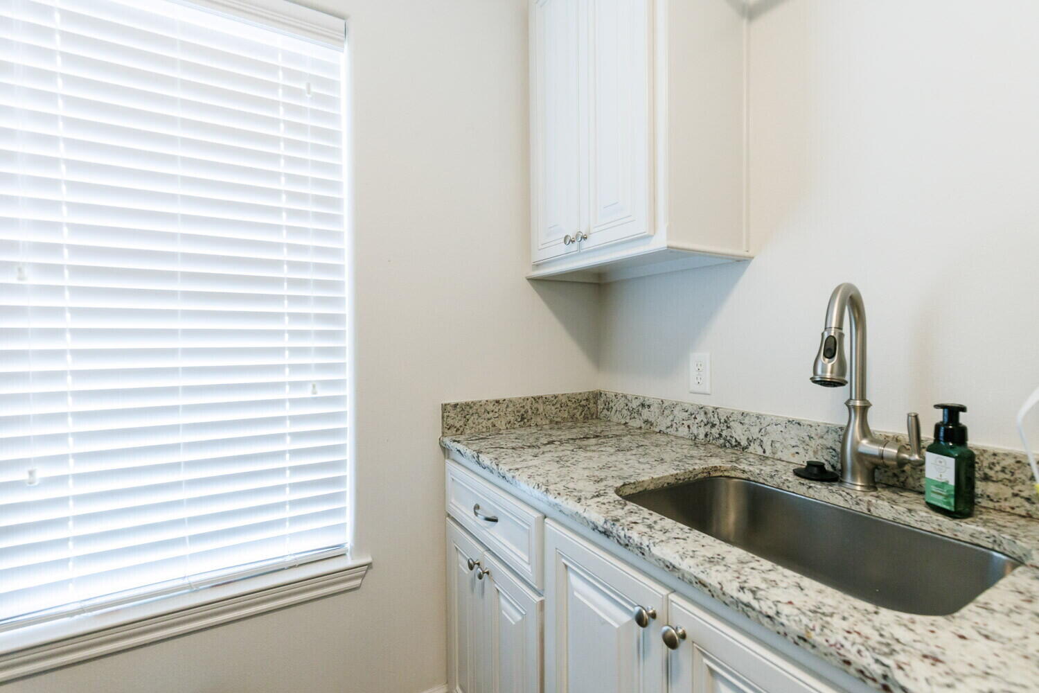 3812 135th Street Lubbock, TX 79423 - Photo 26 of 41 a kitchen with granite countertop a sink and a window