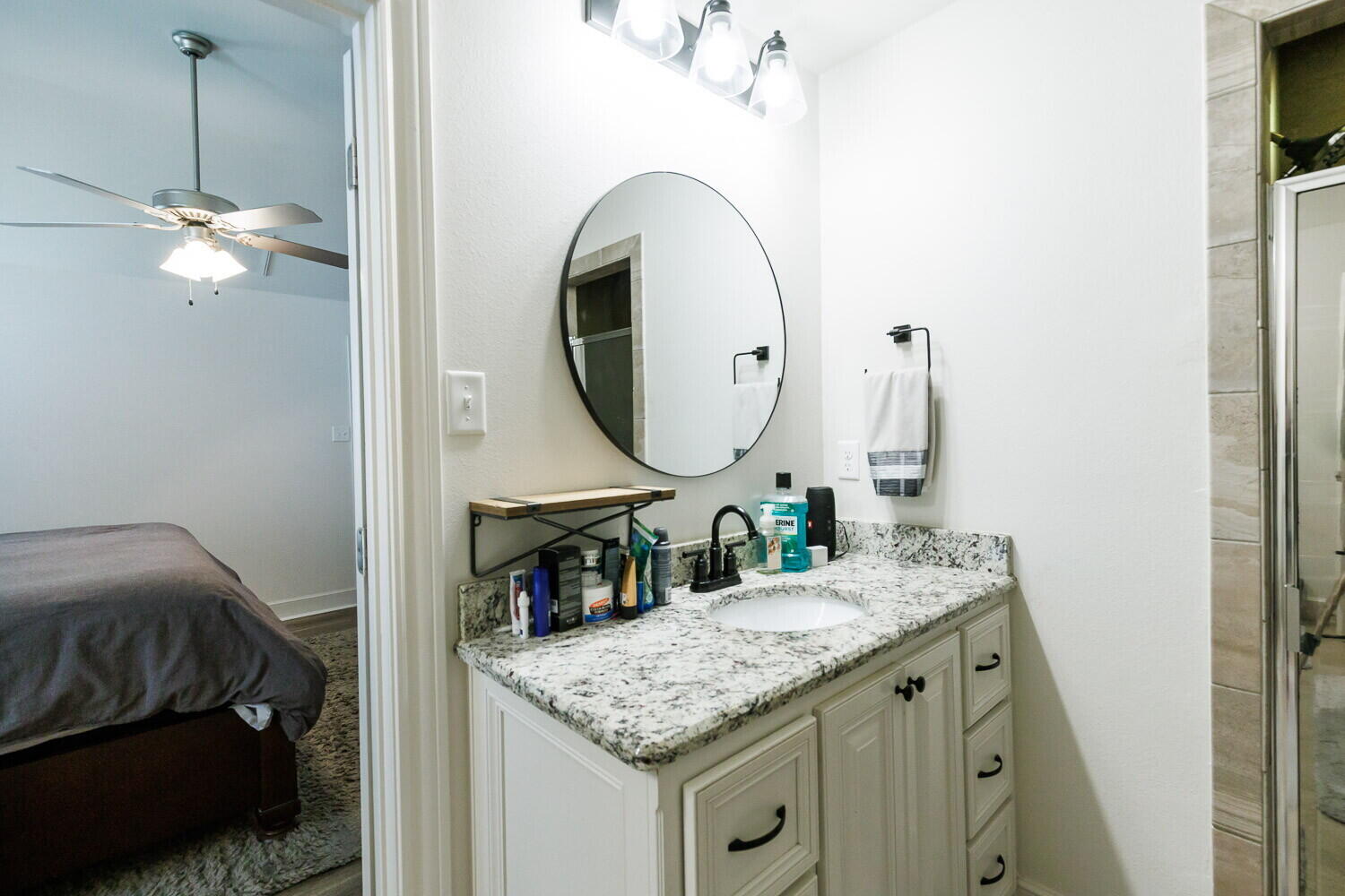 3812 135th Street Lubbock, TX 79423 - Photo 31 of 41 a en suite bathroom with a granite countertop sink and a mirror