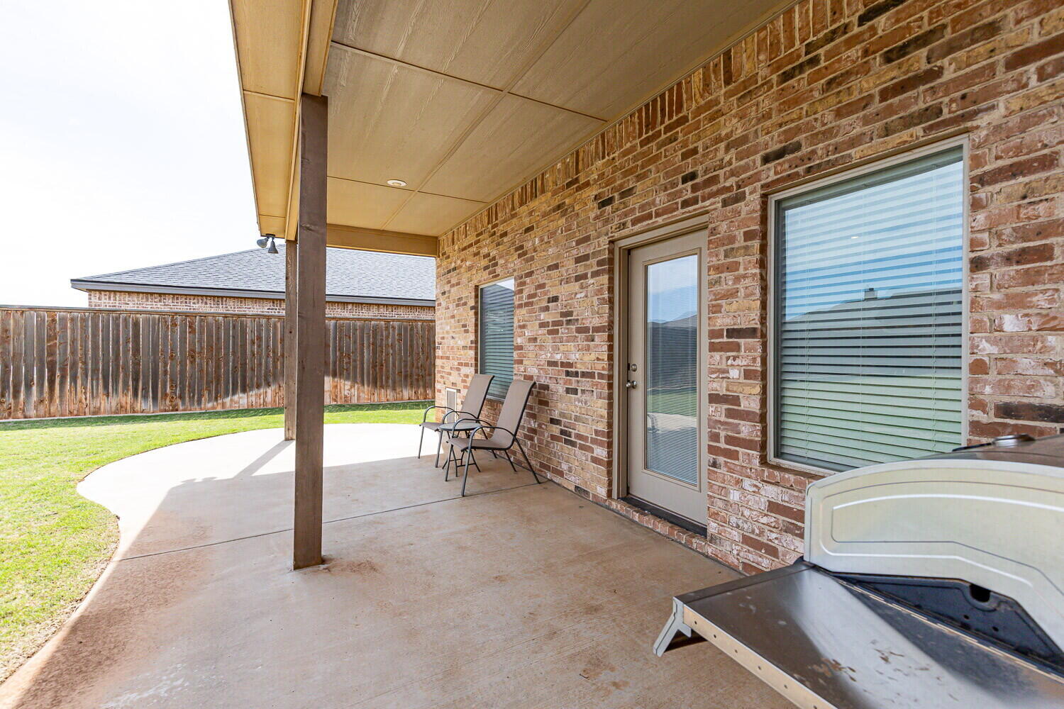 3812 135th Street Lubbock, TX 79423 - Photo 37 of 41 a view of a porch with furniture and floor to ceiling window