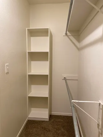 a room with walk in closet and window
