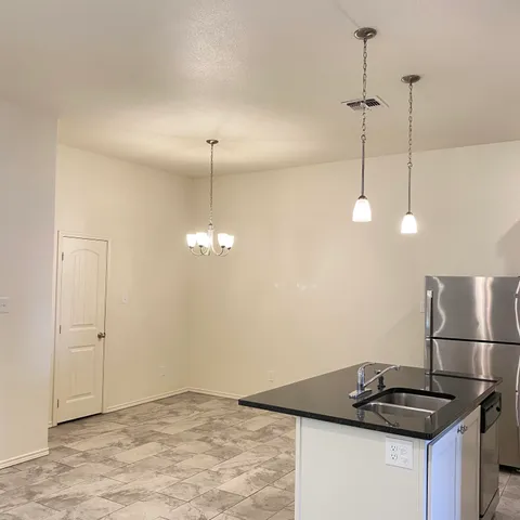a view of a kitchen with a sink and cabinets